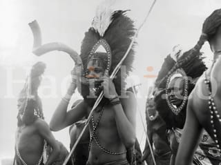 A Moran warrior is seen pictured blowing the horn of a sacred kudu